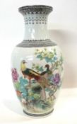 A Chinese porcelain vase of baluster shape with polychrome decoration of peacocks in branches,