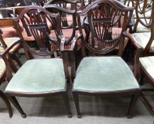 A pair of 20th Century mahogany framed shield back carver chairs