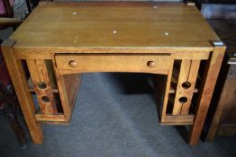 An early 20th Century American mission type desk with central drawer and the sides formed as