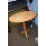 A pine tripod based table with circular top and turned column, top61cm diameter