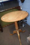 A pine tripod based table with circular top and turned column, top61cm diameter