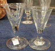 Two 18th Century wine glasses both with trumpet bowls over clear stems, one with an engraved