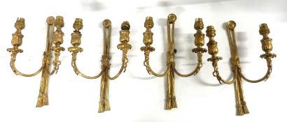 A set of four early 20th Century gilt brass double light wall sconces with tassel decoration, 22cm