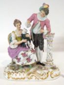 A continental porcelain group of gentleman and lady on oval base with Ludwigsburg porcelain mark