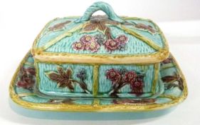 A Maiolica dish and cover, decorated in relief with flowers, 23cm long