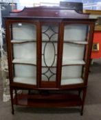 An Edwardian mahogany framed display cabinet, bowed form with a fabric lined interior, set on