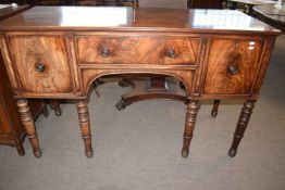 An early 19th Century mahogany sideboard with central shallow drawer, side cupboard and a cellarette