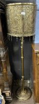An Oriental brass standard lamp with unusual pierced brass shade (Item 23 on vendor list)
