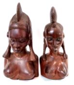 A pair of carved Ethnographica heads of a man and woman, 40cm high