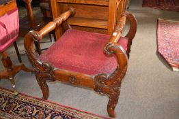 A Victorian oak framed large stool or window seat with scrolled side arms, 70cm wide
