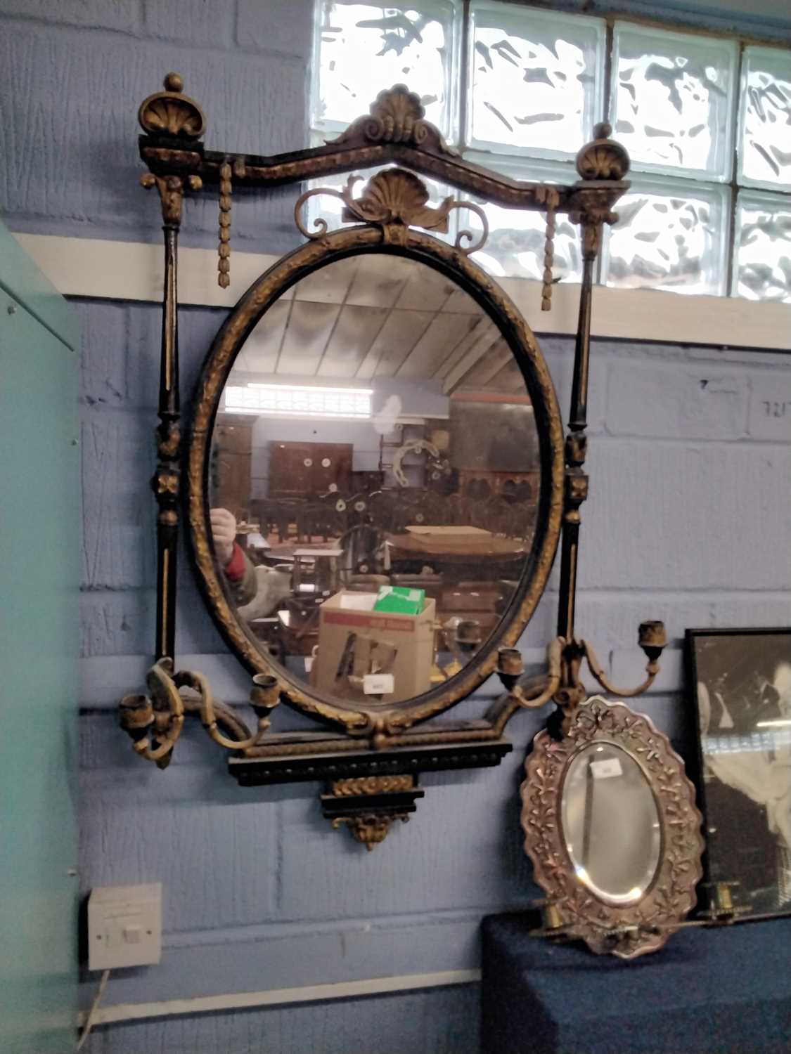 19th Century gilt and ebonised girandole type wall mirror with oval central mirror plate