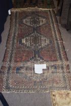 A 19th Century Middle Eastern wool floor rug with central geometric panels, 190 x 95cm, very worn