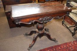 A Victorian rosewood pedestal card table with folding baize lined top, raised on a bulbous column