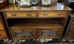 A late Victorian light oak serving sideboard or buffet with two drawers and two panelled doors
