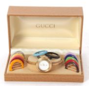 A Gucci 1100L ladies wristwatch with interchangeable bezel, the watch has a quartz movement, a white