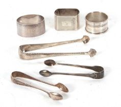 Mixed Lot: Two hallmarked silver serviette rings, a pair of Georgian silver sugar tongs, with