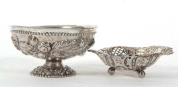 Mixed Lot: A continental white metal pedestal bowl, the body impressed with flowers and leaves, 12cm