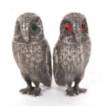 Pair of silver plate owl peppers with green and red inset glass eyes, 6cm tall (2)