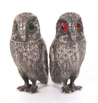 Pair of silver plate owl peppers with green and red inset glass eyes, 6cm tall (2)