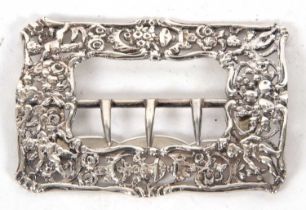 A large Victorian silver cast buckle of pierced rectangular form, cast with cherubs, urns, flowers
