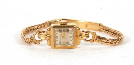 An 18ct gold Movado ladies wristwatch on an 18ct gold bracelet, the watch case is stamped on the