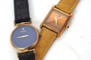 Two Raymond Weil wristwatches, one with a blue dial and the other with a tigers eye style dial, both