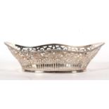 A silver basket of navett form pierced geometric designed sides and beaded rim, import mark for