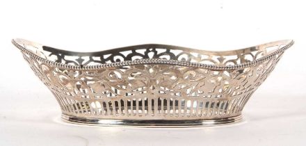 A silver basket of navett form pierced geometric designed sides and beaded rim, import mark for
