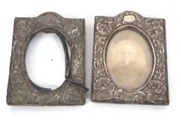 A pair of Edwardian silver photograph frames of rectangular form, elaborately embossed with