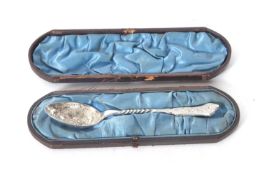 An antique silver plated decorative spoon in a fitted blue velvet lined and leather case (a/f)