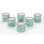 A set of six Cloisonne napkin rings, turquoise ground and decorated in pink, green and yellow