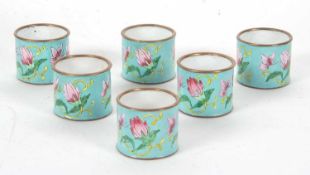 A set of six Cloisonne napkin rings, turquoise ground and decorated in pink, green and yellow