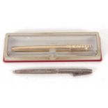 A Sheaffer sterling ball point pen, the barrel engraved with berries and scrolls, the clip a push in