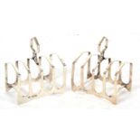 Pair of Art Deco silver toast racks of angular form having four divisions and a central carrying