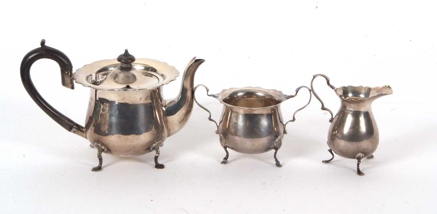 Three pieces of hallmarked silver tea ware to include an Edwardian teapot of baluster form, hinged