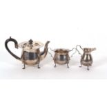 Three pieces of hallmarked silver tea ware to include an Edwardian teapot of baluster form, hinged