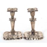 A pair of early 20th Century silver candlesticks (frames only) having detachable nozels, plain