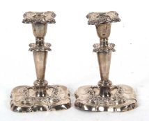A pair of early 20th Century silver candlesticks (frames only) having detachable nozels, plain