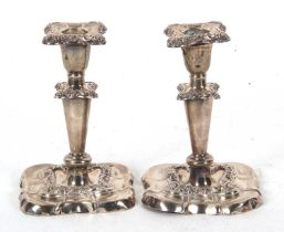 A pair of early 20th Century silver candlesticks (frames only) having detachable nozels, plain