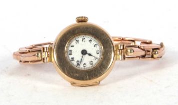 Lady's 9ct gold cased wristwatch on an expanding yellow metal bracelet, the bracelet is stamped