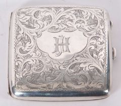 George V silver cigarette case of slightly curved form, chased and engraved with scrolls around an