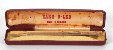 A vintage cased Yard-o-Led rolled gold propelling pencil, the barrel chased and engraved with a