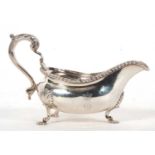 George III large silver sauce boat of typical form, features a gadrooned rim, acanthas capped scroll