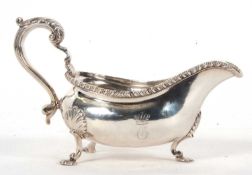George III large silver sauce boat of typical form, features a gadrooned rim, acanthas capped scroll