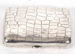 A Victorian silver crocodile skin pattern cigarette case of slight curved rectangular form,
