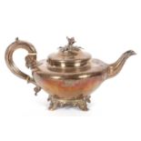 A William IV silver teapot of compressed circular plain form having a cast floral and leaf finial,