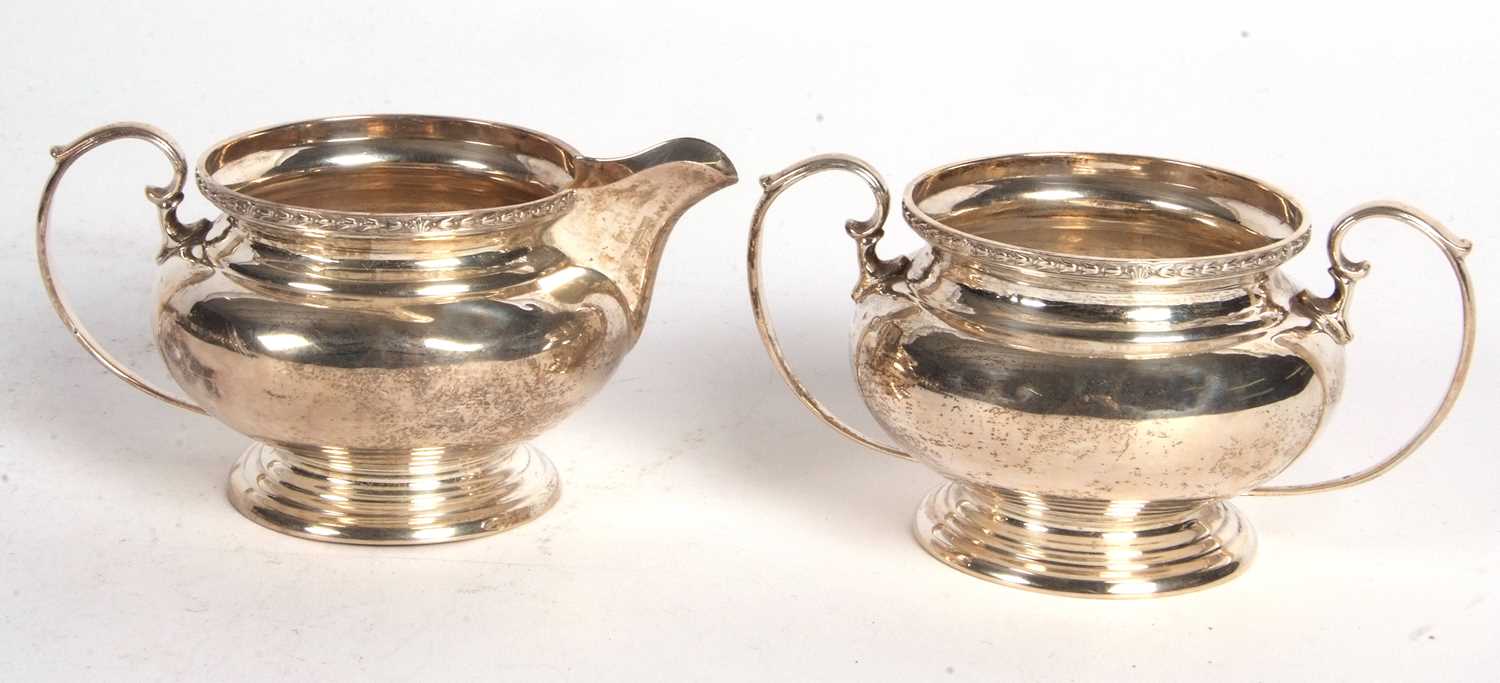 George V silver cream jug and a twin handled sugar bowl of plain squat baluster form, having a - Image 2 of 3