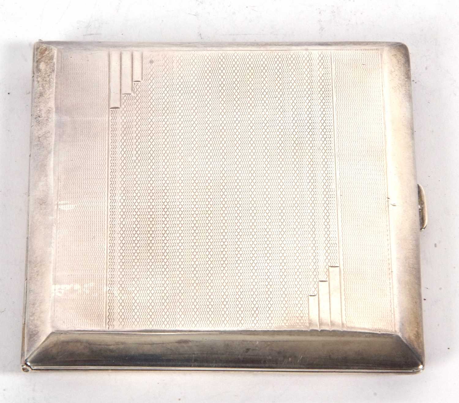 An Art Deco silver cigarette case of rectangular form, engine turned decoration, front and back
