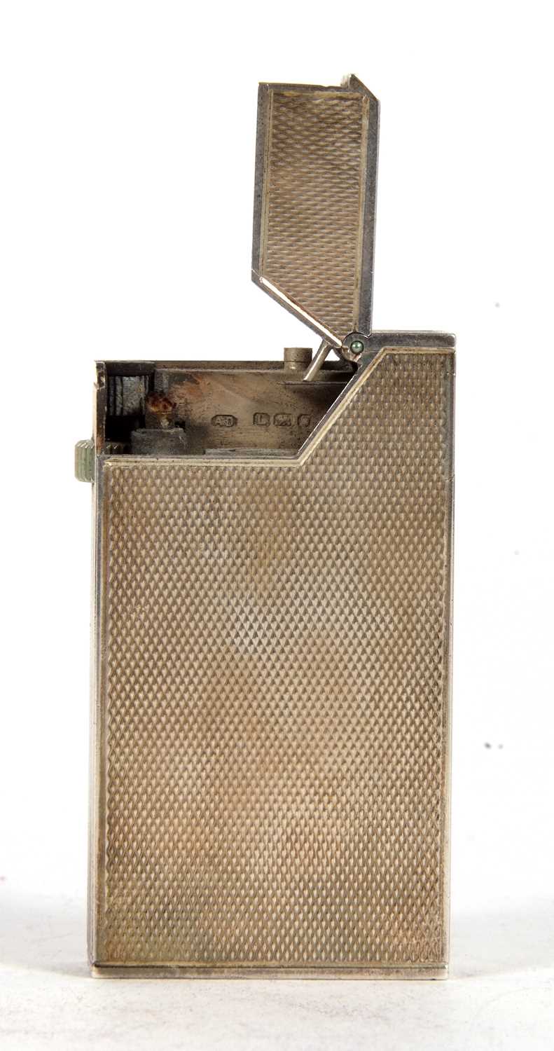 A Dunhill silver lighter PAT No 44007 having all over engine turned decoration, hallmarked London