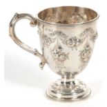 A Victorian silver mug of trophy shape having a capped scroll handle, beaded rim and foot with